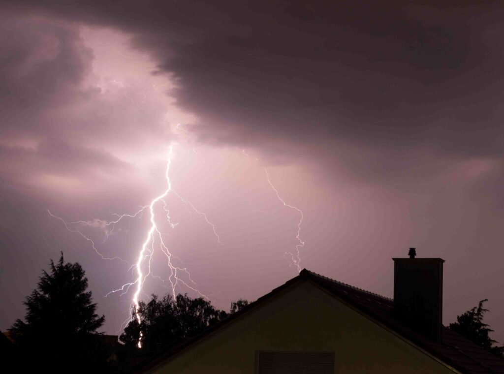 a lightning storm is seen over a house