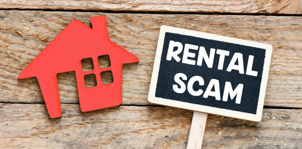 a sign that says rental scam next to a house