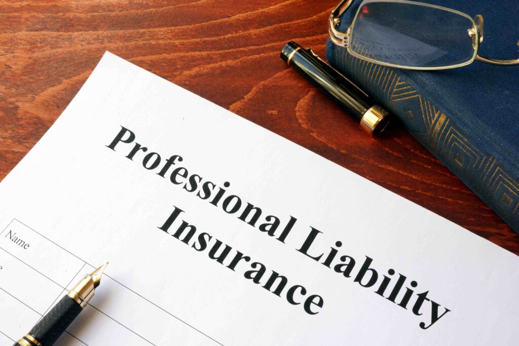 a professional labority insurance form next to a pen and glasses