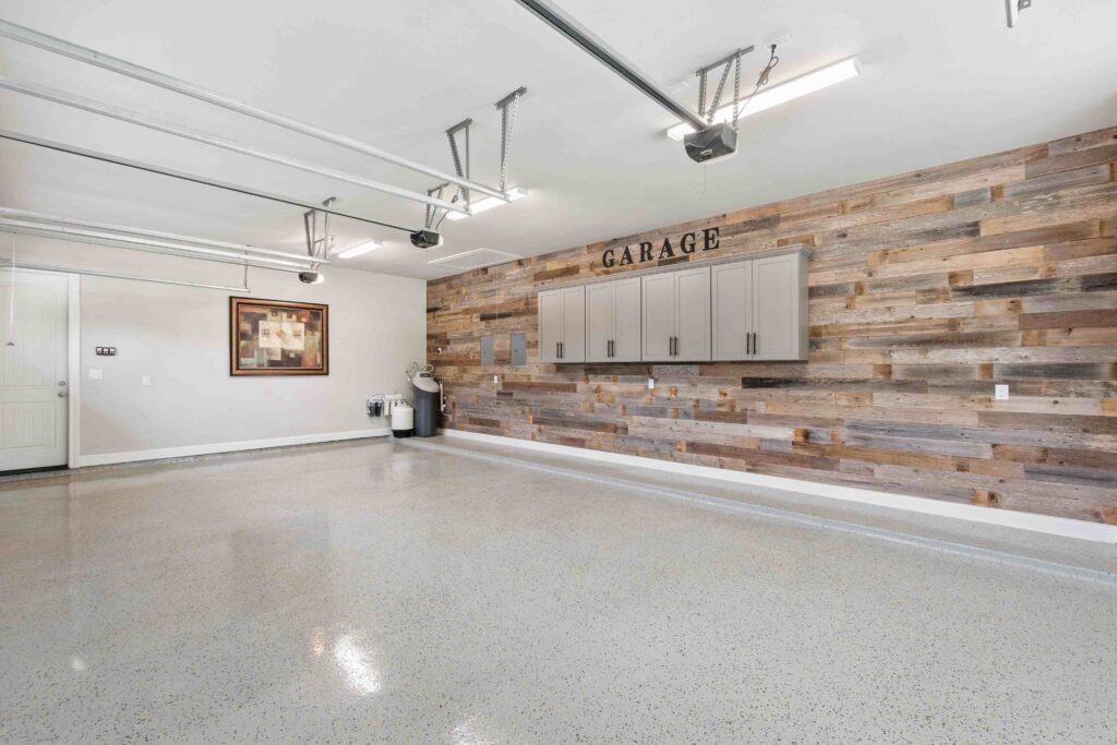 an empty garage with wooden walls and cabinets