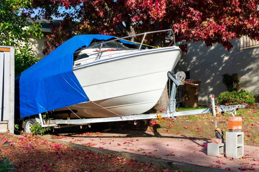 Boat covered in a driveway