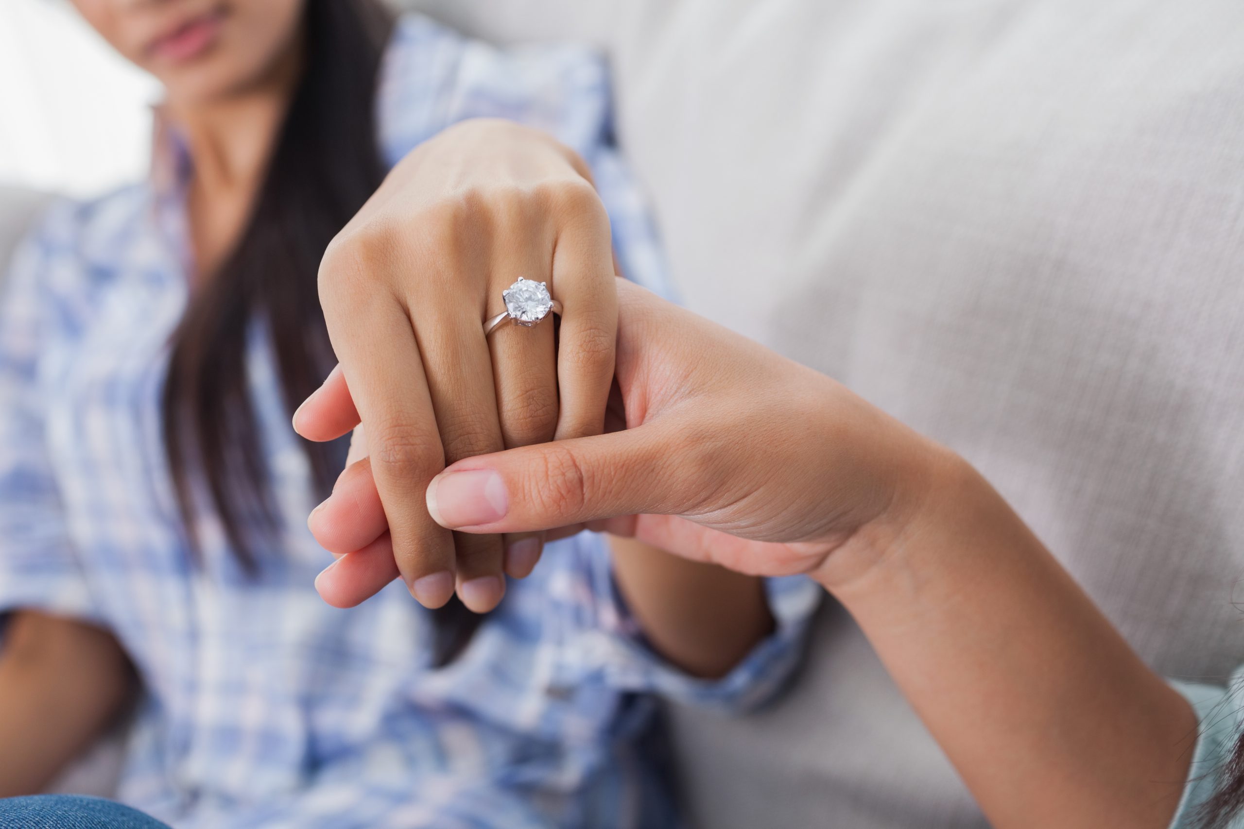 Engagement,Ring,On,Womans,Hand,Held,By,Her,Friend