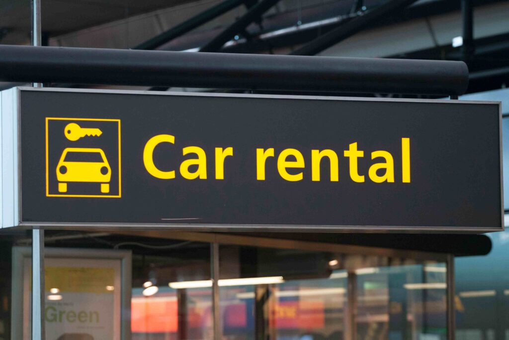 a black and yellow sign that says,'car rental '