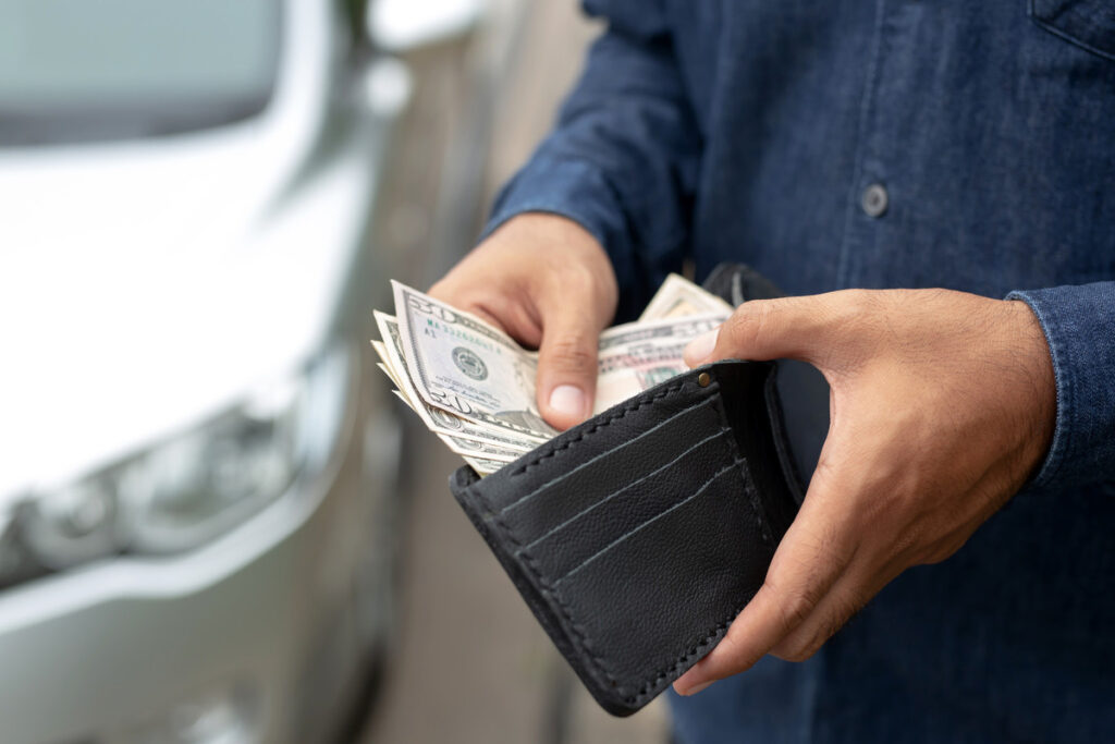 a man holding a wallet and money in his hand