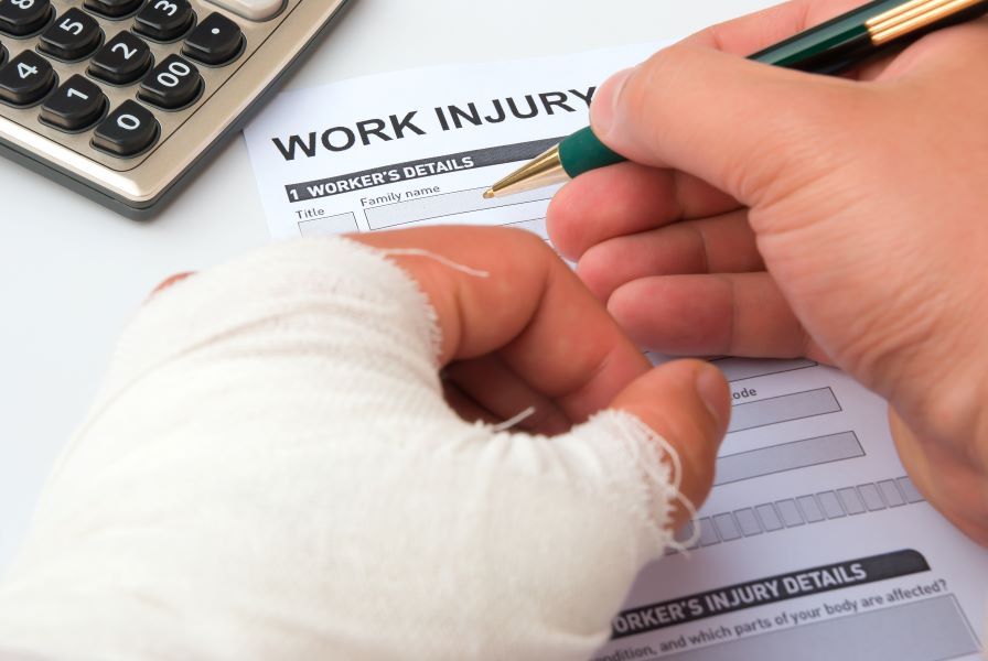 Person with an arm cast signing a work injury form
