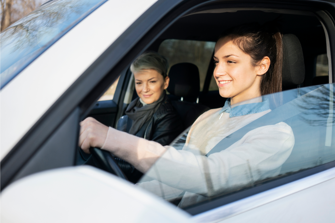 Teen in the car with an adult learning to drive