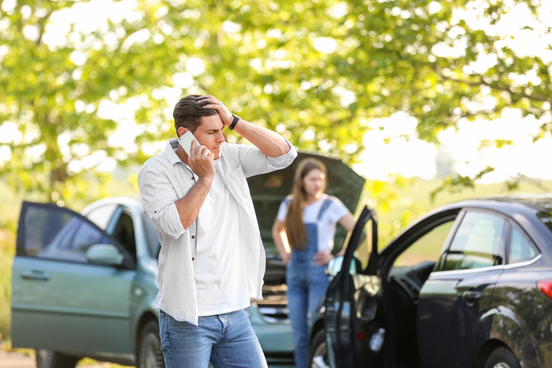 vehicle collision insurance call Man calling insurance after a car accident