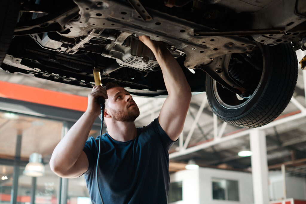 a man working on a car in a garage